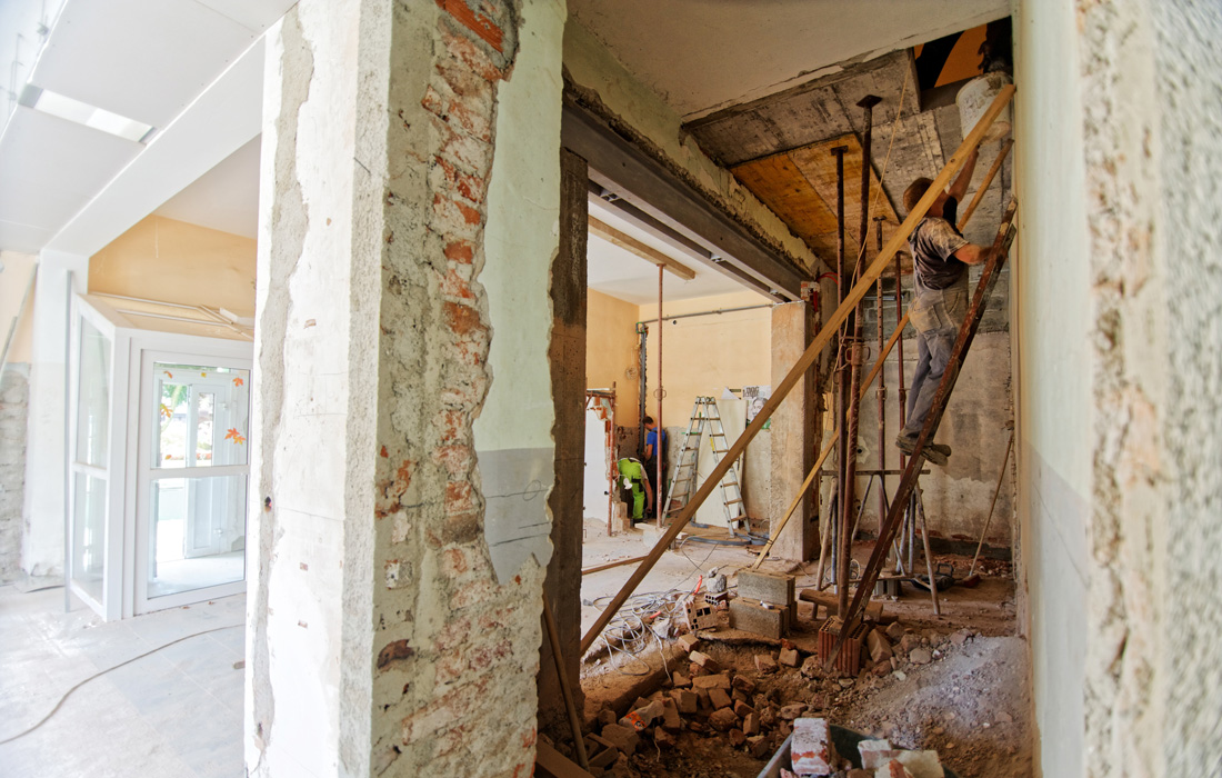 construction worker on a ladder remodeling house